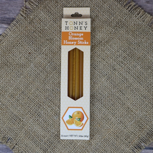 A box of Tonn's Orange Blossom Honey Sticks on rustic burlap.