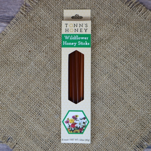 A box of Tonn's Wildflower Honey Sticks on rustic burlap.