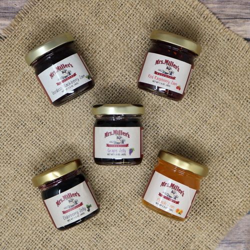 Mini 1.5oz glass jars of Mrs. Miller's Assorted Jams, on rustic burlap.