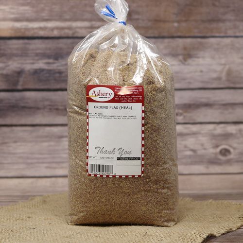 A bag of Flaxseed Meal Brown, sealed with a twist tie, on rustic burlap with a wooden background.