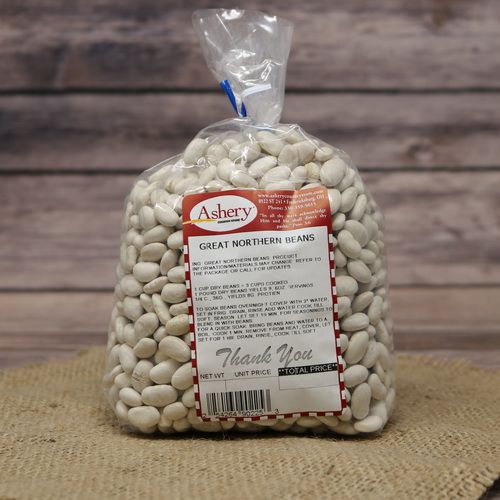 A bag of dried white Great Northern Beans sealed with a twist tea on rustic burlap with a wooden background.