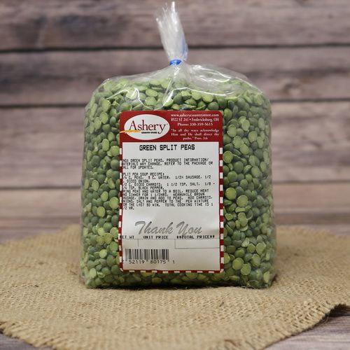 A bag of Green Split Peas sealed with a twist tie on rustic burlap with a wooden background.