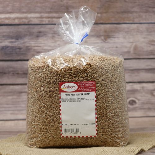 A bag of Hard Red Winter Wheat, sealed with a twist tie, on rustic burlap with a wooden background.