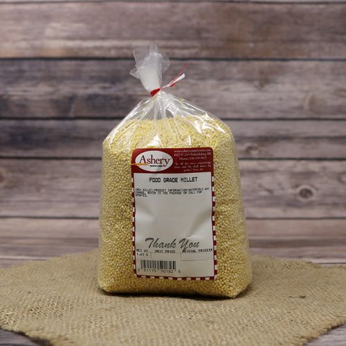 A bag of Food Grade Millet, sealed with a twist tie, on rustic burlap with a wooden background.