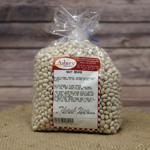 A clear plastic bag of dried Navy Beans sealed with a twist tie on rustic burlap with a wooden background.