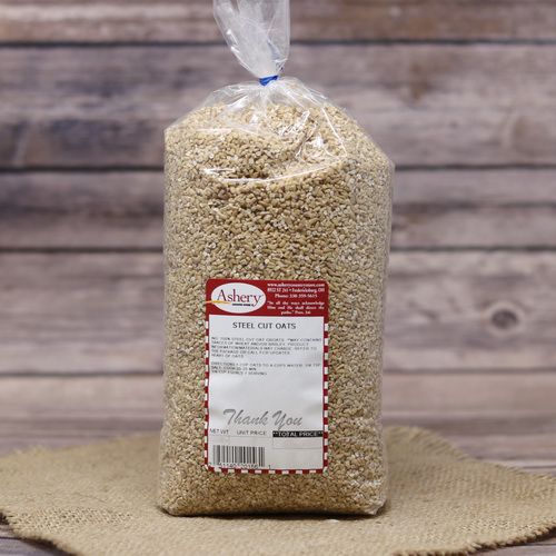 A bag of Steel Cut Oats, sealed with a twist tie, on rustic burlap with a wooden background.