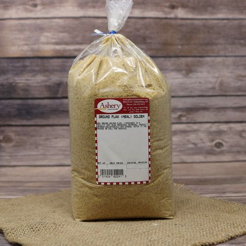 A bag of Flaxseed Meal Golden, sealed with a twist tie, on rustic burlap with a wooden background.