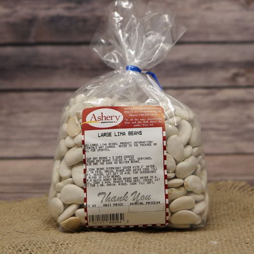 A bag of dried Large Lima Beans sealed with a twist tie on rustic burlap with a wooden background.