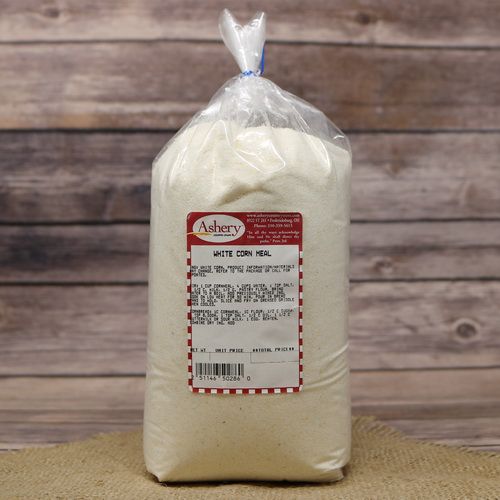 A bag of White Cornmeal, sealed with a twist tie, on rustic burlap with a wooden background.