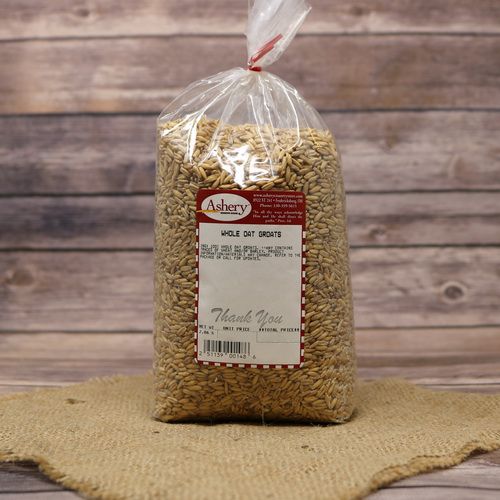 A bag of Whole Oat Groats, sealed with a twist tie, on rustic burlap with a wooden background.