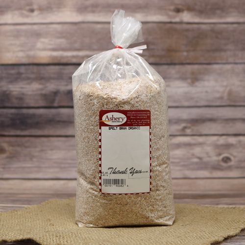 A bag of Organic Spelt Bran, sealed with a twist tie, on rustic burlap and wooden background.