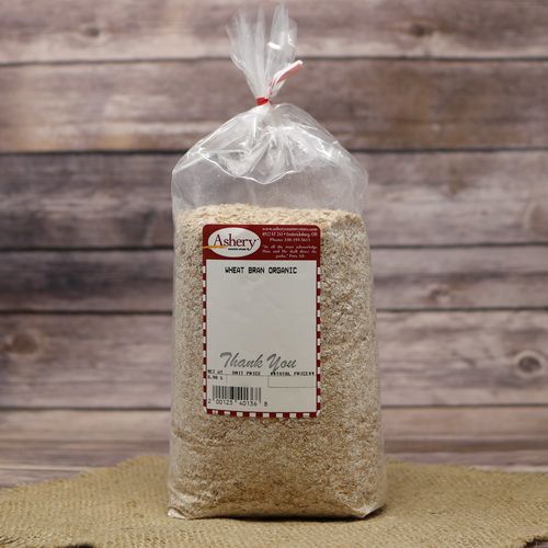 A bag of Organic Wheat Bran, sealed with a twist tie, on rustic burlap and wooden background.