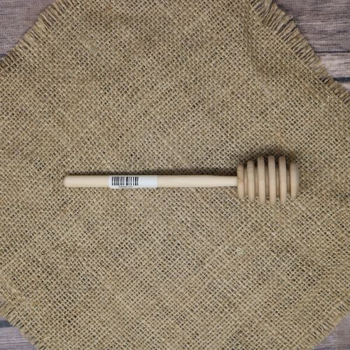 A Honey Dipper on rustic burlap.