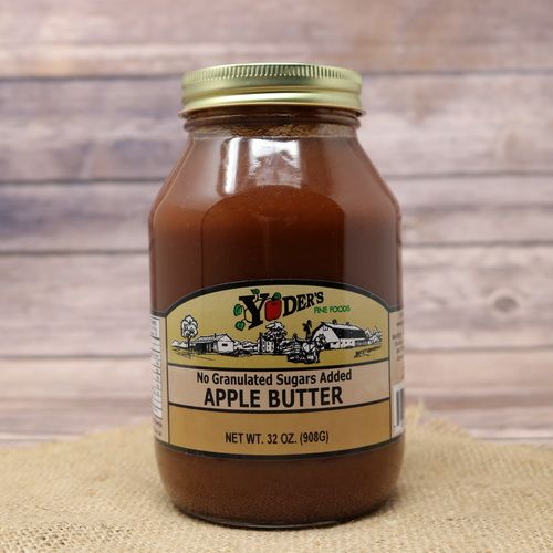 A 32oz glass jar of Yoder's Fine Foods No Sugar Added Apple Butter, on rustic burlap with a wooden background.