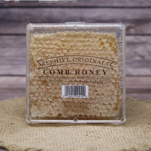 Tonn's Comb Honey in a square container, on rustic burlap with a wooden background.