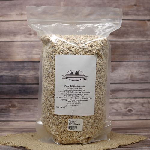 A bag of Whole Cell Crushed Oats 4# on rustic burlap with a wooden background.