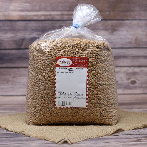 A bag of Sprouted Red Wheat Berries, sealed with a twist tie, on rustic burlap with a wooden background.