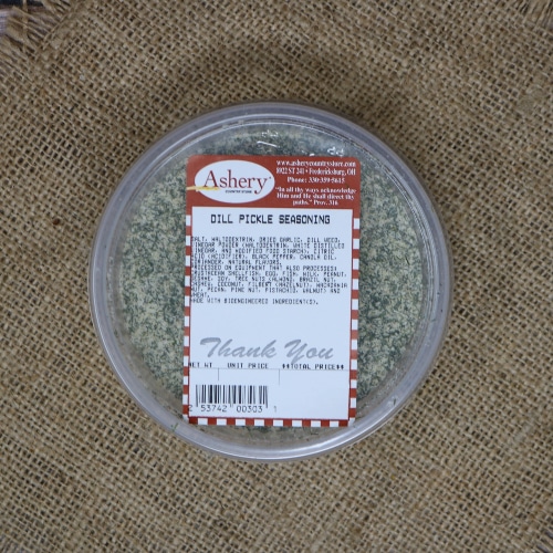 Container of Ashery's Dill Pickle Seasoning with a red label, viewed from above on a burlap texture.