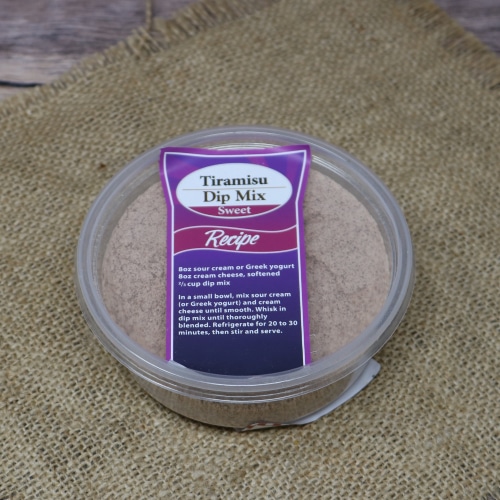 Top view of a container of Tiramisu Dip Mix on a burlap background, with a purple recipe label.