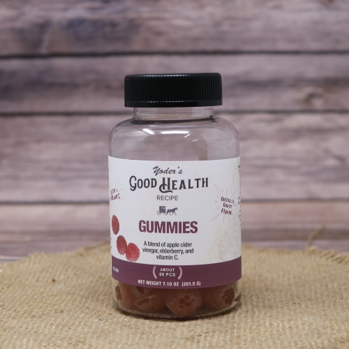 Jar of Yoder's Good Health Recipe Gummies with a purple label, featuring apple cider vinegar, on burlap with a wooden background.
