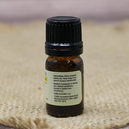 Back of a bottle of Herbal Blessings Helichrysum essential oil showing usage instructions and caution information.