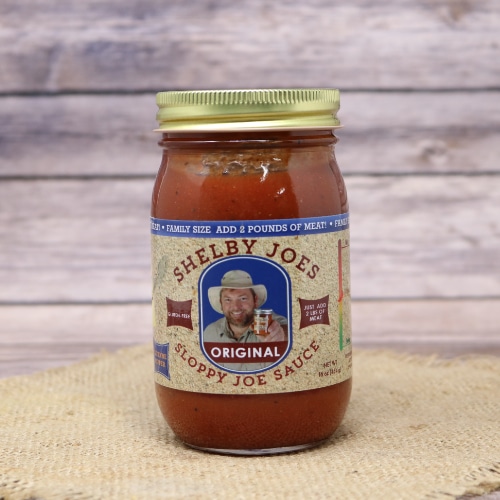 A jar of Sloppy Joe Sauce Original on rustic burlap and a wooden background.